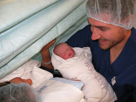 parents-holding-newborn-baby-by-beccaplusmolly.jpg