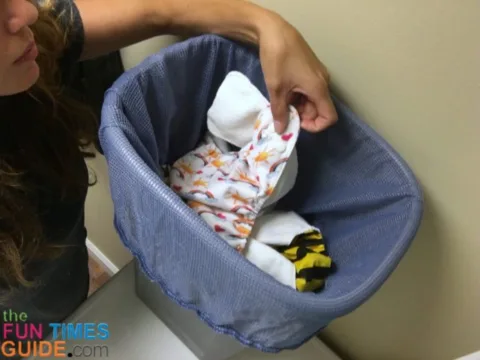 Dirty cloth diapers in the diaper pail - the pockets and the inserts are separated before placing them in the diaper pail.