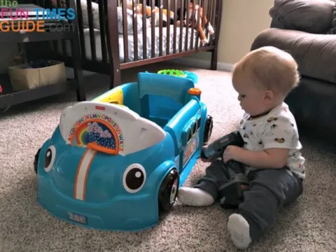 My one year old pretending to 'fix' the Fisher Price Crawl Around Car.