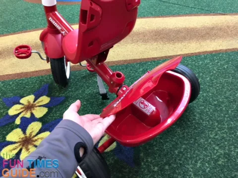 There's a small covered bin for storage on the Radio Flyer 4-in-1 trike.