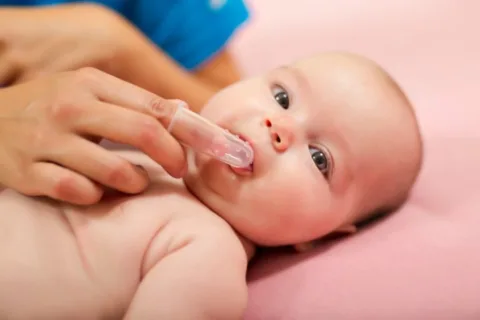 Wondering how to brush baby teeth with an infant? Use a finger brush like this or a wet washcloth!