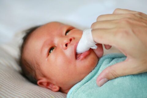 If your baby doesn't have any teeth yet, it's still important to wipe your baby's gums with a wet washcloth or gauze to remove bacteria that can build up after feedings.